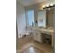 Bathroom featuring a tub with tile flooring, single sink vanity, and natural light from window at 2305 Summit Dr, Hillsborough, NC 27278