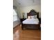 Bedroom with a queen-sized bed, a window, wood floors, bedside table, and a ceiling fan at 2305 Summit Dr, Hillsborough, NC 27278