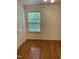 Bright bedroom with hardwood floors, window, and white trim at 2305 Summit Dr, Hillsborough, NC 27278