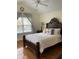 Vaulted bedroom featuring a queen-sized bed, wooden floors, bedside table, and a ceiling fan at 2305 Summit Dr, Hillsborough, NC 27278