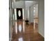 Inviting foyer with gleaming hardwood floors and a view into other rooms at 2305 Summit Dr, Hillsborough, NC 27278