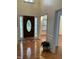 Welcoming foyer with hardwood floors, wood trim, and a decorative front door with sidelights at 2305 Summit Dr, Hillsborough, NC 27278