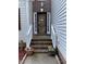 A beautiful front entrance with brick steps, potted plants, and an inviting wooden door at 2305 Summit Dr, Hillsborough, NC 27278