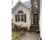 Charming front porch with brick steps, seasonal flowers, and inviting entrance to a lovely home at 2305 Summit Dr, Hillsborough, NC 27278