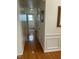Narrow hallway with hardwood floors, neutral paint, and traditional moldings at 2305 Summit Dr, Hillsborough, NC 27278