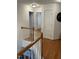 Upstairs hallway with hardwood floors, white banister, and neutral paint at 2305 Summit Dr, Hillsborough, NC 27278