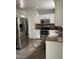 Modern kitchen features stainless steel appliances, granite countertops, and updated tile backsplash at 2305 Summit Dr, Hillsborough, NC 27278