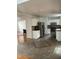 Open concept kitchen with stainless appliances, white cabinets, and a seamless transition to the dining area at 2305 Summit Dr, Hillsborough, NC 27278