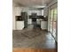 Bright kitchen with stainless steel appliances, white cabinets, and sliding glass door to outdoor deck at 2305 Summit Dr, Hillsborough, NC 27278