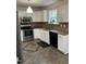Well-maintained kitchen with stainless steel appliances, white cabinets, and granite countertops at 2305 Summit Dr, Hillsborough, NC 27278
