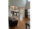 Open-concept living room with hardwood floors flowing into an adjacent kitchen, perfect for entertaining at 2305 Summit Dr, Hillsborough, NC 27278