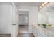 Bright bathroom features a double vanity with view to bedroom and neutral tile floors at 2411 Vancastle Way # 202, Raleigh, NC 27617