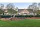 Community clubhouse with fountain, lovely lawn, and mature trees at 2411 Vancastle Way # 202, Raleigh, NC 27617