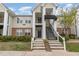 Inviting exterior view of a two-story condo building, boasting well-maintained landscaping and charming architectural details at 2411 Vancastle Way # 202, Raleigh, NC 27617