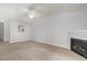 Spacious living room with a cozy fireplace, neutral carpet, and bright white walls showcasing an open floor plan at 2411 Vancastle Way # 202, Raleigh, NC 27617