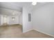 Open floorplan with carpeted floors, offering a versatile living space with ceiling fans at 2411 Vancastle Way # 202, Raleigh, NC 27617