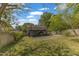 Large backyard with driveway leading to parking under a deck, with a grassy area at 2522 N Roxboro St, Durham, NC 27704