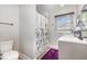 Bathroom featuring a shower, vanity with sink, dark fixtures, and a window bringing in natural light at 2522 N Roxboro St, Durham, NC 27704