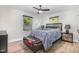 Cozy bedroom with a ceiling fan, two windows, and a comfortable bed with stylish accent pillows at 2522 N Roxboro St, Durham, NC 27704
