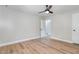 Empty bedroom featuring a ceiling fan, closet, and a door leading to another room at 2522 N Roxboro St, Durham, NC 27704