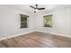 Empty bedroom featuring a ceiling fan, wood floors, and two windows that bring in natural light at 2522 N Roxboro St, Durham, NC 27704