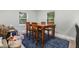 Dining area showcasing a wooden table with four chairs and a blue rug, with nearby toys at 2522 N Roxboro St, Durham, NC 27704