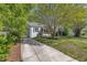 Lovely home with a brick facade, side driveway, mature tree, and well-maintained lawn at 2522 N Roxboro St, Durham, NC 27704