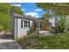 Beautiful home featuring a brick facade, covered porch, a bright yellow door, and landscaped front yard at 2522 N Roxboro St, Durham, NC 27704