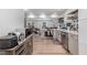 Open-concept kitchen featuring stainless steel appliances, gray cabinets, and seamless flow into the living space at 2522 N Roxboro St, Durham, NC 27704