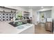 Modern kitchen featuring a quartz countertop island, star patterned backsplash, and stainless steel appliances at 2522 N Roxboro St, Durham, NC 27704