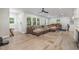 Open living room with large sectional couch, light wood flooring, and plenty of natural light at 2522 N Roxboro St, Durham, NC 27704