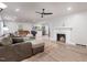 Open-concept living room featuring a sectional sofa, fireplace, and seamless flow into the kitchen at 2522 N Roxboro St, Durham, NC 27704