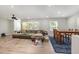 Bright living room featuring a large sectional, wood floors, and easy access to the dining area at 2522 N Roxboro St, Durham, NC 27704