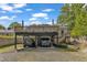 Parking underneath a deck with two cars, gravel drive, and landscaped planter at 2522 N Roxboro St, Durham, NC 27704