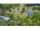 Expansive aerial shot capturing the house near the golf course with a picturesque pond at 254 Pine Forest Dr, Siler City, NC 27344