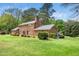 Home's expansive backyard with mature trees and landscaping provides ample space and privacy at 254 Pine Forest Dr, Siler City, NC 27344