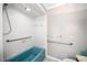 Bathroom with blue retro bathtub, white tile walls, and accessibility features at 254 Pine Forest Dr, Siler City, NC 27344