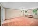 Spacious bedroom with classic striped wallpaper, windows, and soft pink carpet at 254 Pine Forest Dr, Siler City, NC 27344
