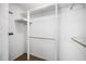 Empty white closet with shelving and a wooden bar for hanging clothes at 254 Pine Forest Dr, Siler City, NC 27344