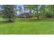 Traditional brick home with black shutters set on a large manicured lawn at 254 Pine Forest Dr, Siler City, NC 27344