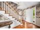 Bright foyer featuring hardwood floors, staircase, and floral wallpaper at 254 Pine Forest Dr, Siler City, NC 27344
