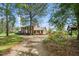 Charming two-story brick home with classic black shutters and a meticulously landscaped front yard at 254 Pine Forest Dr, Siler City, NC 27344