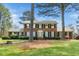Classic brick home with symmetrical design, complemented by mature trees and green lawn at 254 Pine Forest Dr, Siler City, NC 27344