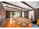 Spacious living room with hardwood floors, exposed beams, and a wall of windows at 254 Pine Forest Dr, Siler City, NC 27344