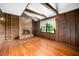 Rustic living room with brick fireplace, wood paneling, ladder to loft at 254 Pine Forest Dr, Siler City, NC 27344