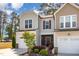 Charming home featuring a welcoming facade, landscaped yard, and attached garage at 301 White Oak Ridge Dr, Garner, NC 27529