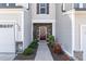 Inviting front entrance with a decorative wreath, landscaping, and a 'Welcome' sign at 301 White Oak Ridge Dr, Garner, NC 27529