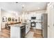Bright, eat-in kitchen with stainless steel appliances, island with granite countertops, and adjacent dining area at 301 White Oak Ridge Dr, Garner, NC 27529