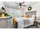 Cozy bedroom features a ceiling fan, bright window, and stylish decor at 301 White Oak Ridge Dr, Garner, NC 27529