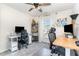This office space has 2 computer desks, ceiling fan, window and neutral carpet at 301 White Oak Ridge Dr, Garner, NC 27529
